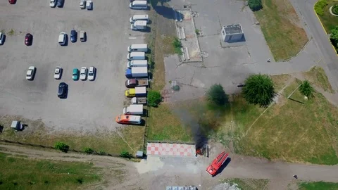 Firefighters extinguish burning garbage can, aerial Stock Footage 95448803