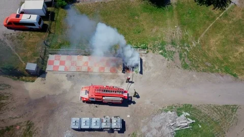 Firefighters extinguish burning garbage can, aerial Stock Footage 95448965
