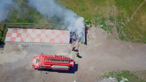 Firefighters extinguish burning garbage can, aerial Stock Footage 95449295