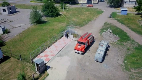 Firefighters extinguish burning garbage can, aerial Stock Footage 95450117