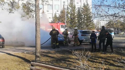 Firefighters extinguish car fire outside. lot of thick white smoke Stock Footage 309240314