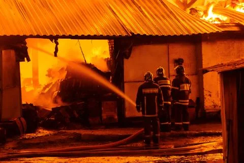 Firefighters extinguish a fire Stock Photos
