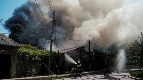 Firefighters extinguish huge house fire with large plumes of black smoke ri.. Stock Footage 339792373