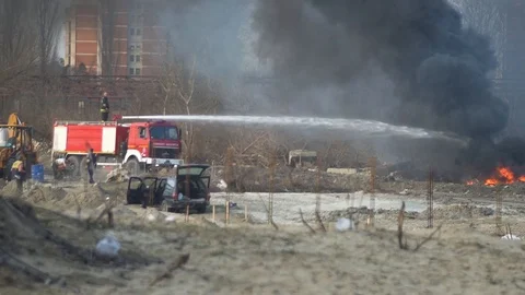Firefighters extinguishing fire on a wild garbage depo Stock-Footage 104801647