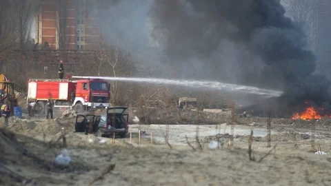 Firefighters extinguishing fire on a wild garbage depo Stock-Footage 104801655