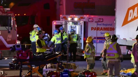 Firefighters Extricating At Major Crash While Paramedics Load Patient Stock Footage 70798069