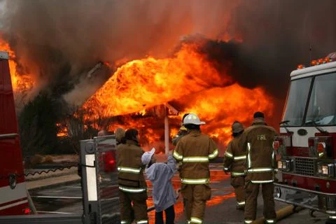Firefighters & Family Watch a Control Burn House Fire at a Safe Distance Stock Photos