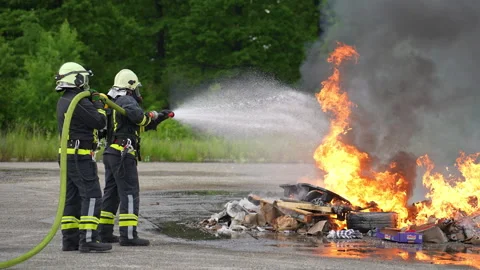 Firefighters fight the fire flame to control fire not to spreading out Stock Footage 247791687