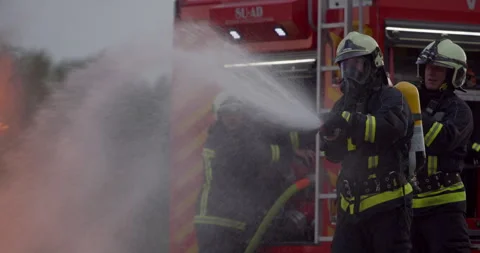 Firefighters fight the fire flame to control fire not to spreading out Stock Footage 247801666
