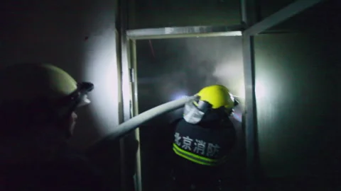 Firefighters fighting the fire at night, Beijing, China Stock Footage 143004007