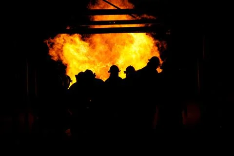 Firefighters fighting fire Stock Photos