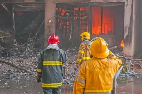 Firefighters fighting fire Stock Photos