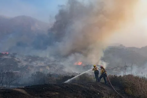 Firefighters fighting Fire Stock Photos