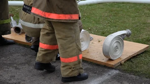 Firefighters with fire hoses ready to be shown on the teachings Stock Footage 124019052