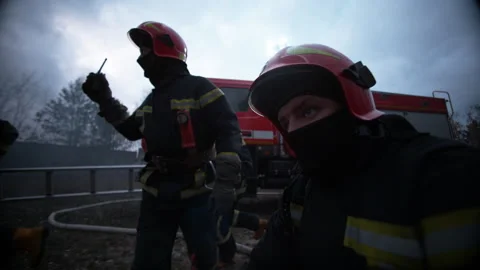 Firefighters in front of a fire truck Stock Footage 283180594