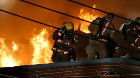 Firefighters getting mask off with flames Stock Footage 116119297