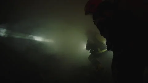 Firefighters going through the smoke Stock Footage 283142777