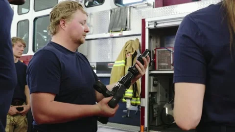 Firefighters inspecting equipment in fire station Stock Footage 220204882
