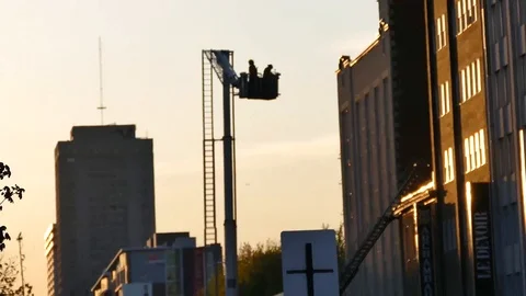 Firefighters ladder moving during a sunset Stock Footage 90336992