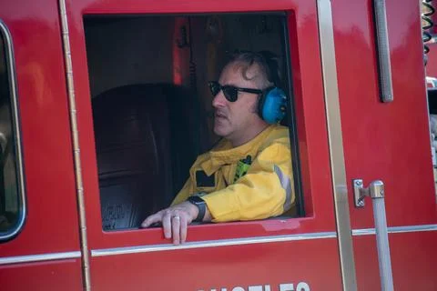 Firefighters from LAFD Engine 104 stand by at the scene of a brush fire in Ch Stock Photos