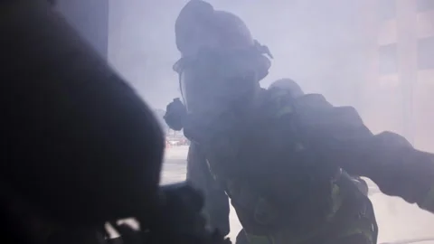 Firefighters open door to burning building filled with smoke and enter Stock Footage 133597628