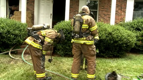 FIREFIGHTERS OUTSIDE HOUSE Stock Footage 93402283