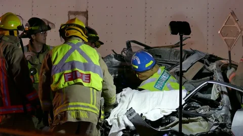Firefighters Perform First Aid On Crash Patient With Paramedics Video stock 70817628