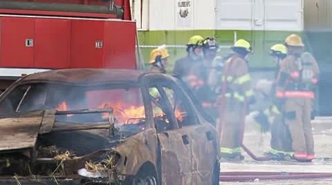 Firefighters Preparing to Extinguish a Burning Car Stock Footage 10749241