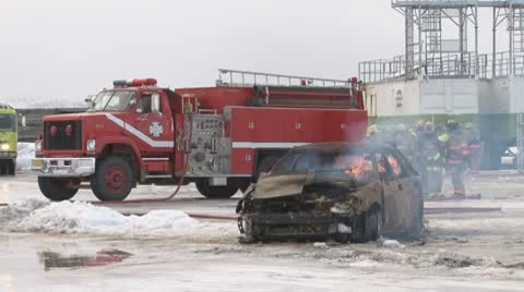 Firefighters Preparing to Extinguish a Burning Car wide Stock Footage 10787819
