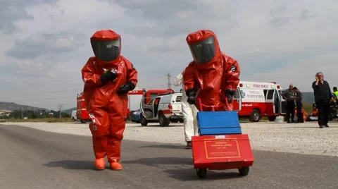 Firefighters with Protective suit getting tests samples israel 2026 war 스톡 동영상 40480999