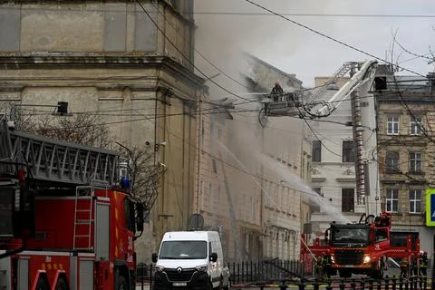 Firefighters put out the fire in a building Stock Photos