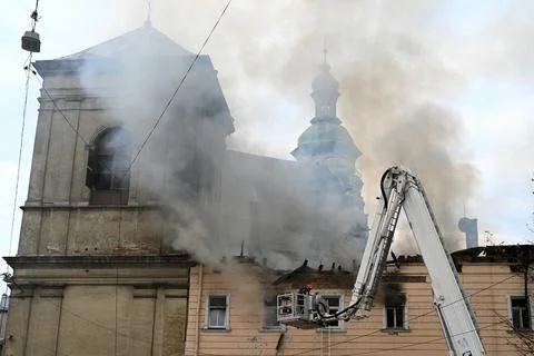 Firefighters put out the fire in a building following a Russian drone attack Stock Photos