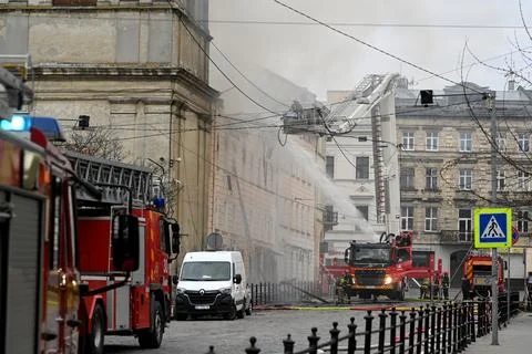 Firefighters put out the fire in a building. Stock Photos