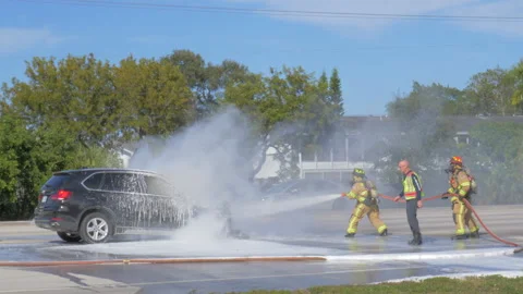 Firefighters Put Out Fire in Burning Vehicle Stock Footage 169749365
