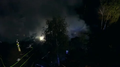 Firefighters Put Out Flames in the Dark. The toxic smoke poisons the Stock Footage 232114329