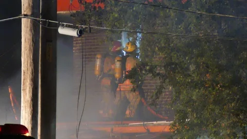 Firefighters putting water from balcony Stock Footage 114765962