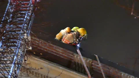 Firefighters on the roof at active structure fire Stock Footage 139663835