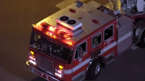 Firefighters rush across an intersection view from above Vidéo 76260601