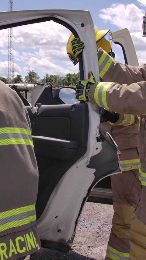 Firefighters on the scene with a car crash performing a rescue Stock Footage 330984068