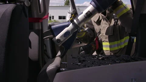 Firefighters on the scene with a car crash performing a rescue Stock Footage 330984076