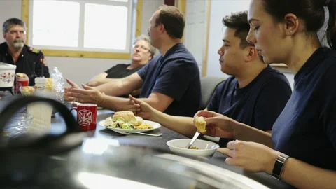 Firefighters sharing a meal and talking in fire station Stock Footage 220205670