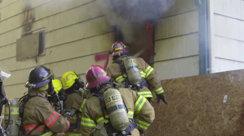 Firefighters spray water on fire Stock Footage 60737361