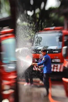 Firefighters spray water Stock Photos