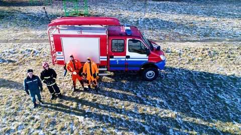 Firefighters stand near the fire engine Stock Footage 94566686
