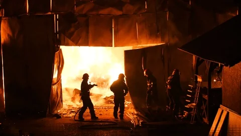 Firefighters Stopping A Burning Warehouse Stock-Footage 91329632