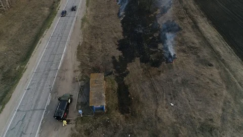 Firefighters Stretched Hoses To Extinguish The Fire. Fire on the Side of the Roa Stock Footage 127835993