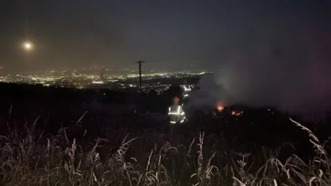 Firefighters tackle a gorse fire in the Belfast Hills  Stock Footage 312906291