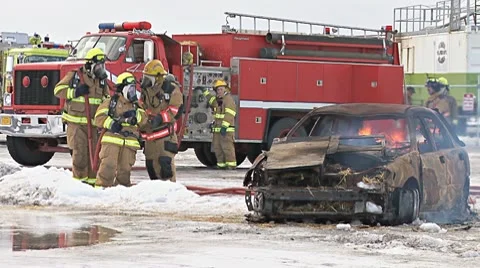 Firefighters Training with Burning Car 1 Stock Footage 10749935