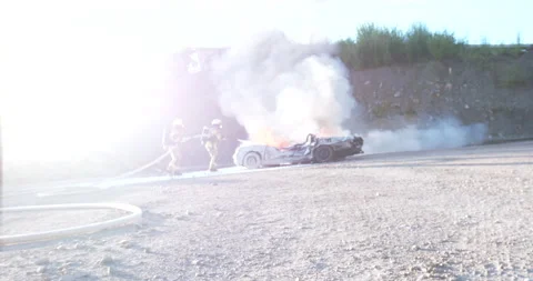 Firefighters training to extinguish a burning car 스톡 동영상 266415945
