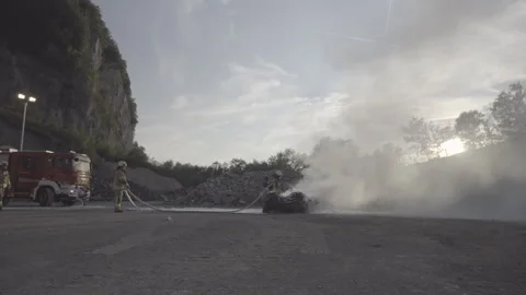 Firefighters training to extinguish a burning car 스톡 동영상 266883010